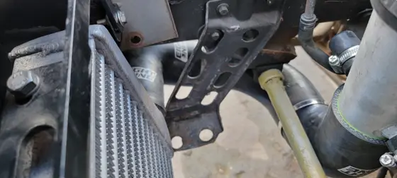 Routing charge pipes around the front structure