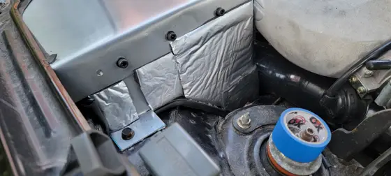 Airbox mounting tabs and sound-deadening material